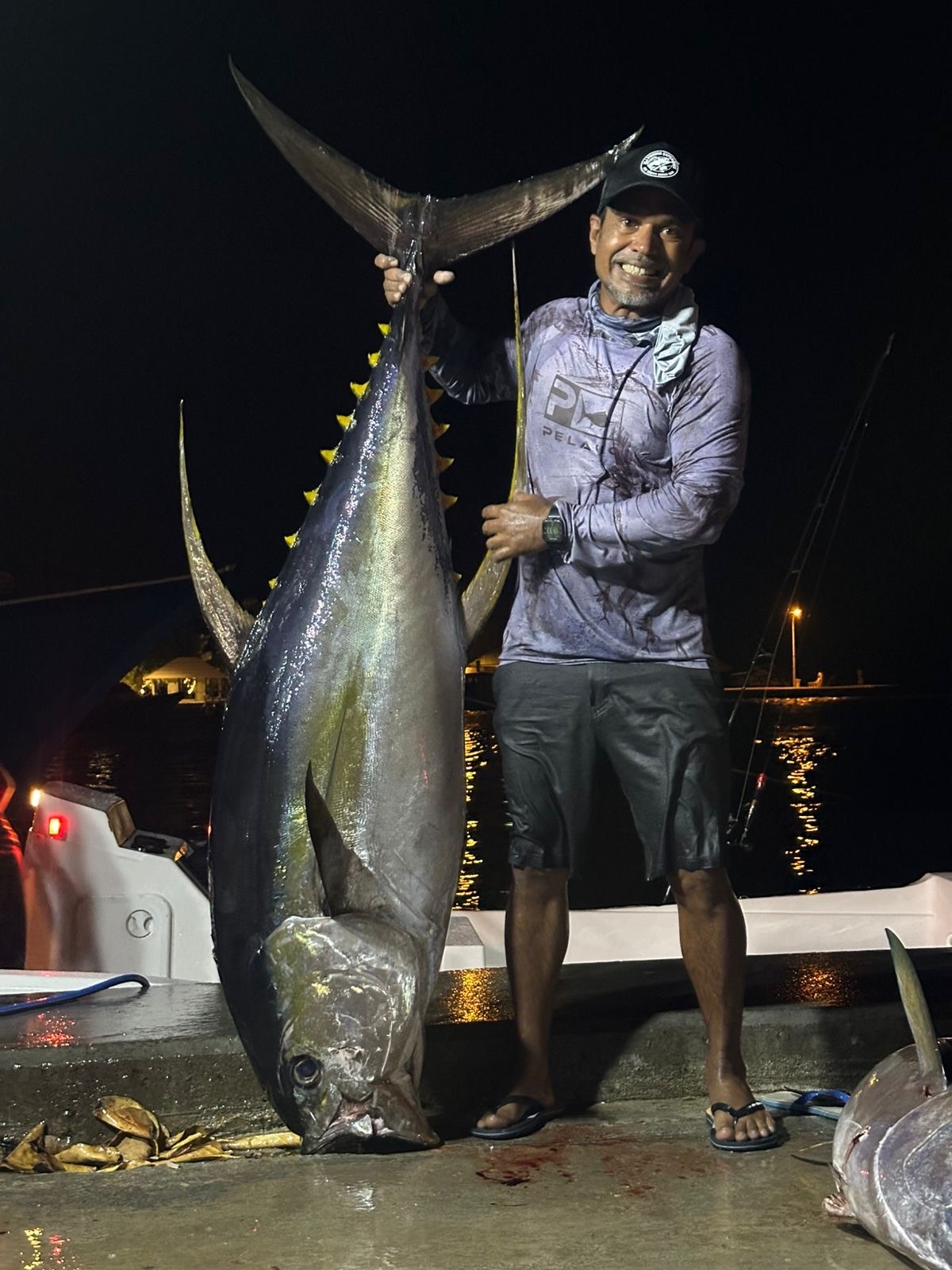 Jordy, SALTRIPS owner and guide, with a giant yellowfin tuna at Goidhoo harbour at night